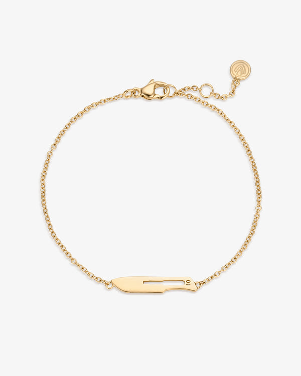 Gold bracelet featuring a 10 Blade charm on a white background
