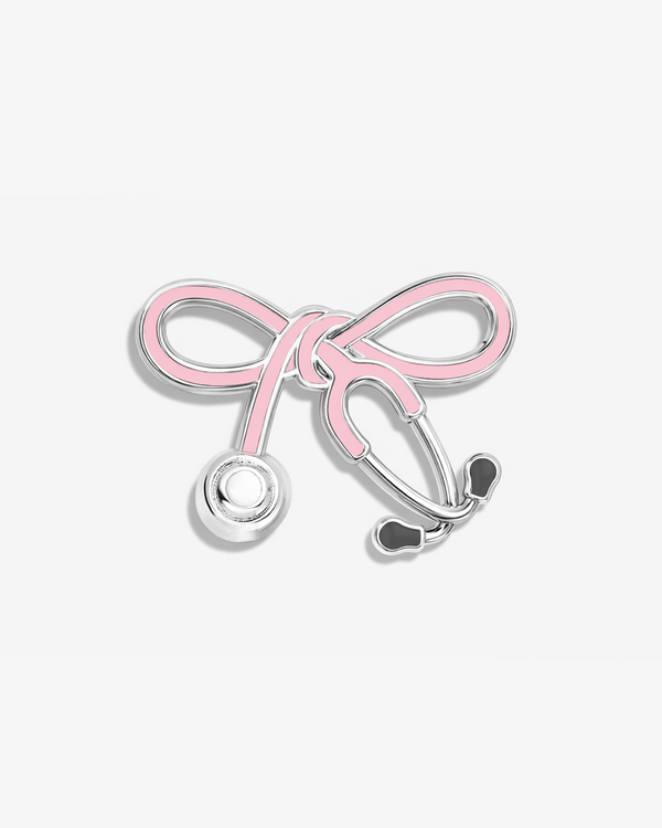 Pink bow-shaped stethoscope pin or brooch on a white background