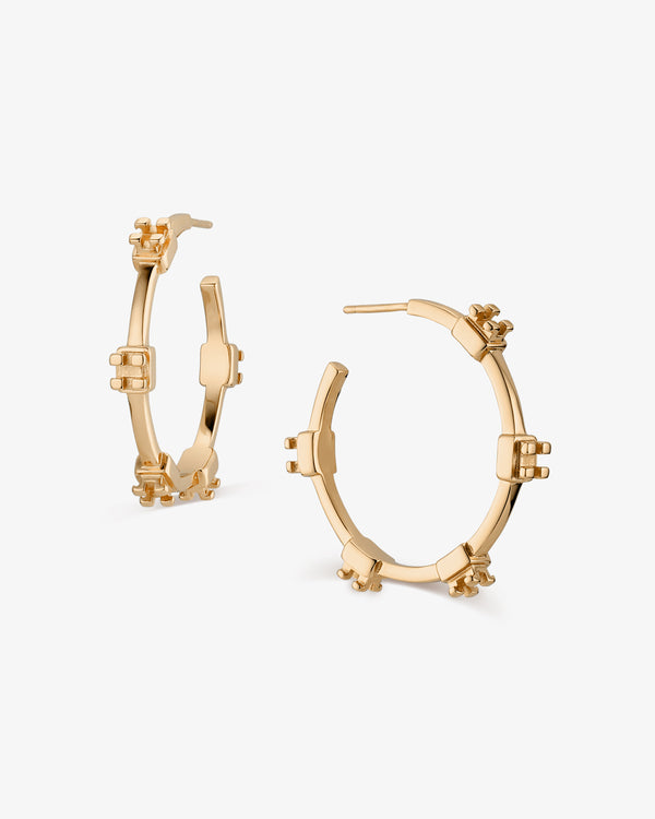 Gold hoop earrings with orthodontic braces bracket details on a white background