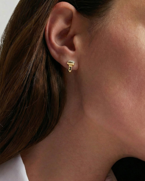 Close-up of a person wearing a gold earring featuring a unique ultrasound probe